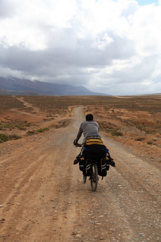 Morocco, Cirque du Jaffar. Cyclist on the road from Midelt