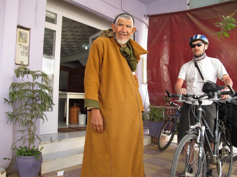 Morocco, Midelt. Russian cyclist and berber man