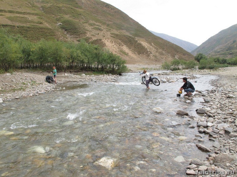 Tajikistan, Rufigar. River wade with bicycle