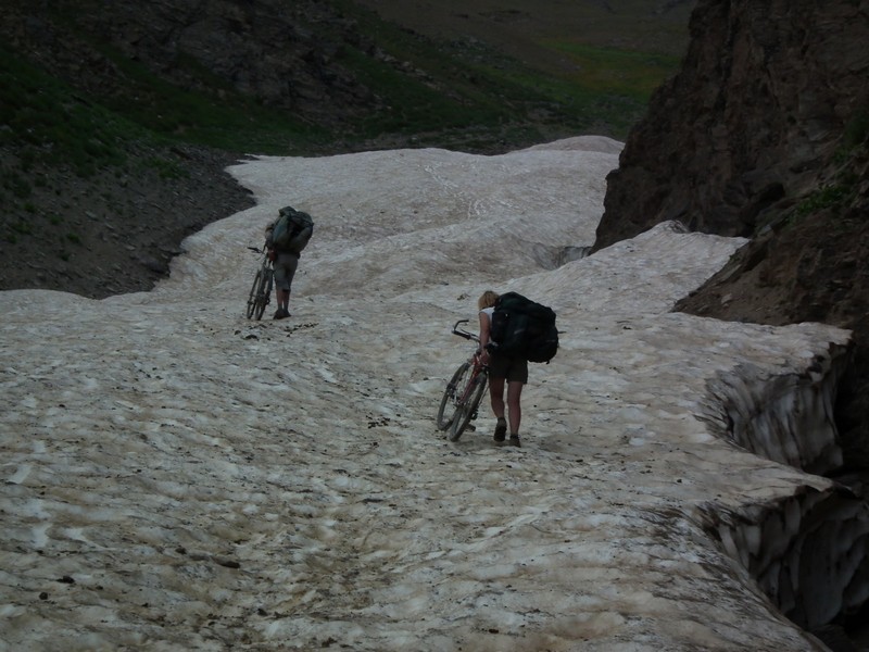 Tajikistan, Rost pass. Climbing glacier with bicycles