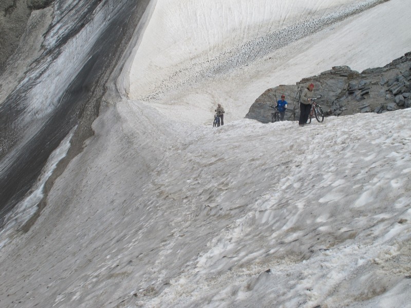 Tajikistan, Rost pass. Walking on glacier edge with bicycles