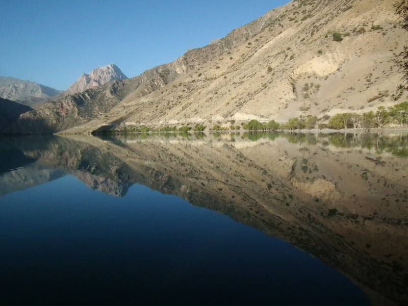 Iskanderkul lake. Morning still water.