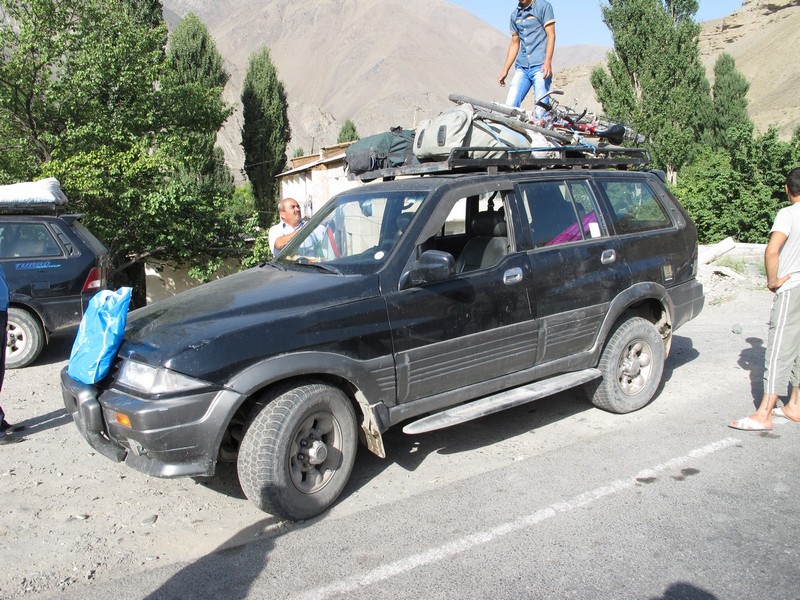 Tajikistan. Aini load bicycles to jeep