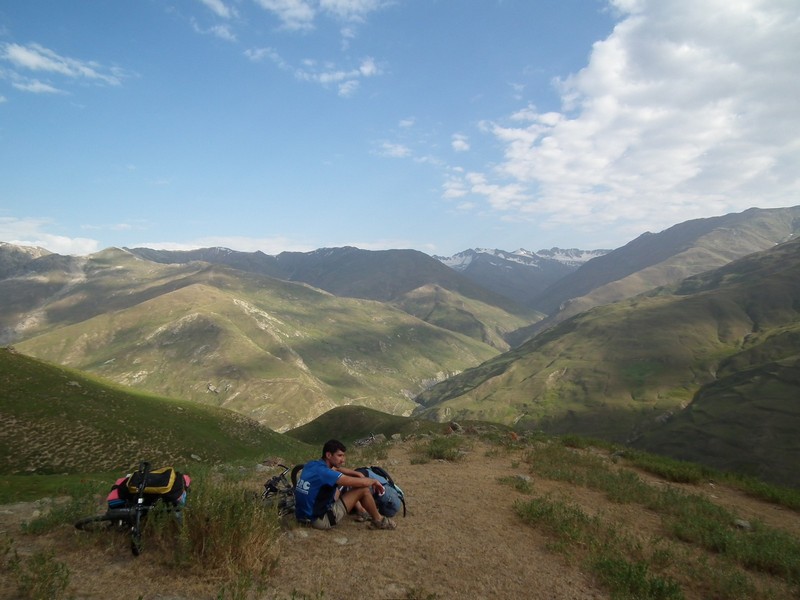 Tajikistan, Yagnob. Cyclist resting on the hill