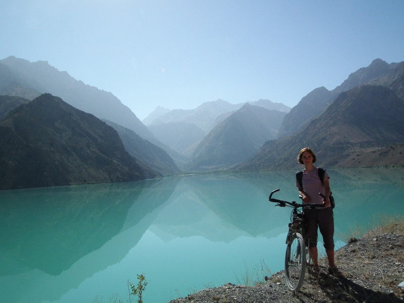 Iskanderkul lake. Cyclist on the bank